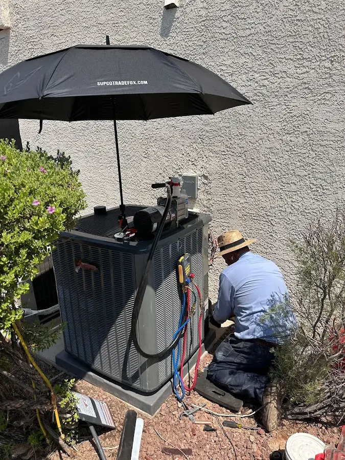 HVAC technician performing outdoor AC maintenance in Wedgefield